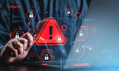 Cybersecurity warning concept with red alert symbol and digital padlocks over person holding...
