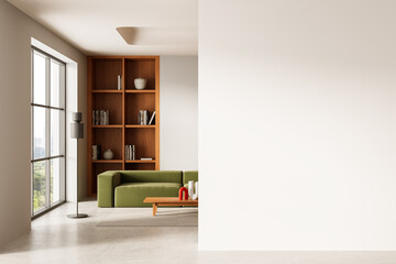 Modern interior with empty white wall mockup and stylish green sofa near wooden shelves in living...