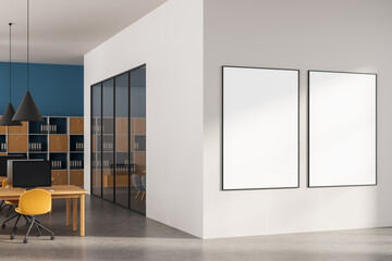 Modern office interior with two blank poster frames on white wall in contemporary workspace with wooden furniture and glass partition wall. 3D Rendering