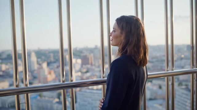 Successful lady standing balcony highrise building enjoy city view closeup. 