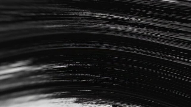 A black and white, abstract motion background with subtle texture and soft blur, showing horizontal lines moving in a dynamic and fluid wave-like pattern.