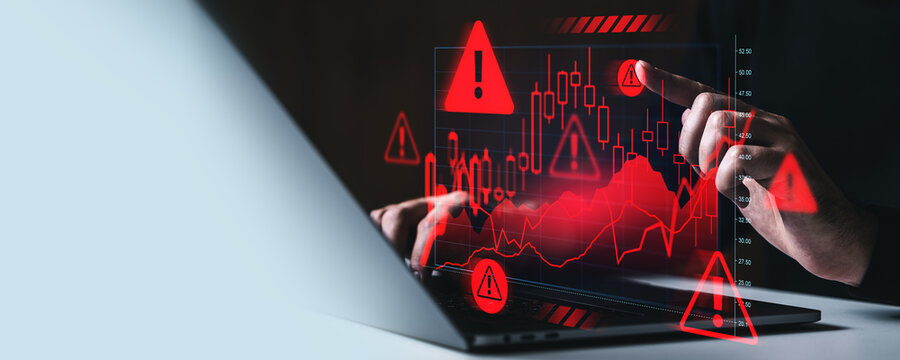 Financial crisis warning concept with trader analyzing falling stock market chart and red alert icons on screen in futuristic digital interface..