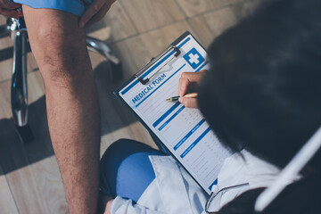 Physical therapist teaching a patient how to do exercises for his knee pain