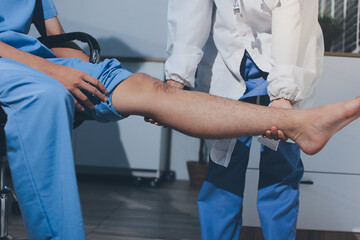 Physical therapist teaching a patient how to do exercises for his knee pain
