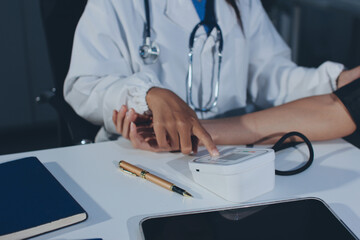 Doctor checking patient arterial blood pressure in hospital. Health care Concept