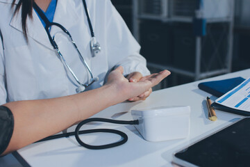 Doctor checking patient arterial blood pressure in hospital. Health care Concept