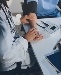 Doctor checking patient arterial blood pressure in hospital. Health care Concept