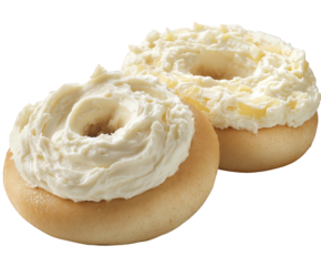 Two bagels generously topped with cream cheese, isolated on transparent background