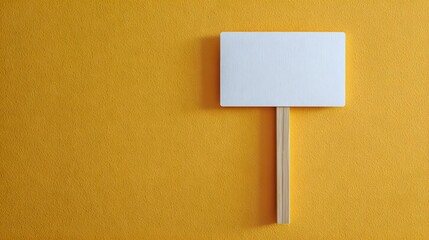 Minimalist Blank Sign on Wooden Stick Against Vibrant Yellow Textured Background