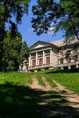 Majestic palace surrounded by lush greenery and towering trees, showcasing stunning architecture and inviting atmosphere for travel enthusiasts. Ukraine.