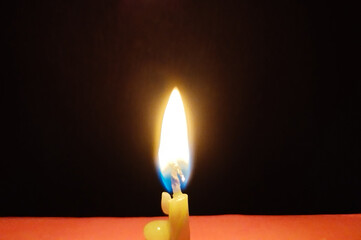 Single Burning Candle in the Dark And Symbol of Hope and Peace