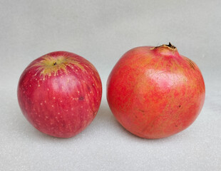 Fresh Red Apple and Pomegranate on White Background