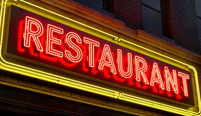 Neon Restaurant Signboard Illuminated on Urban Brick Wall at Night