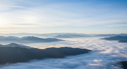 Naklejka premium Serene high-angle vista of a mountain range covered by a sea of mist at dawn, creating a tranquil and scenic natural panorama