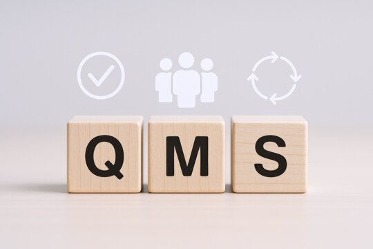 Quality Management System Concept: Wooden Blocks Displaying QMS for Business Process Improvement and Compliance