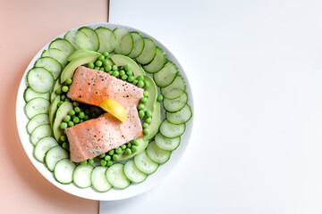 Top View of Scottish Salmon Fillets High in Protein and Omega 3 with Avocado, Cucumber and Green Peas, Healthy Organic Diet