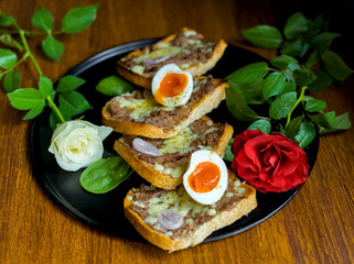 Close-up of Gourmet Balkan Princess Minced Beef and Pork Snack Appetizer Toast with Eggs and Roses