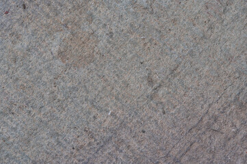 Close-up textured gray concrete surface with visible aggregate and subtle color variations