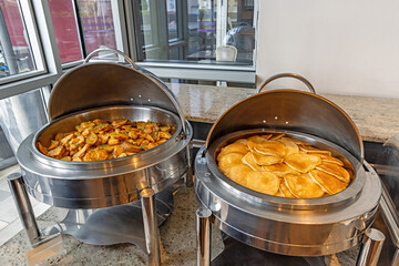 American pancakes and roasted potatoes served at a buffet breakfast