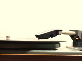 Close-up of vinyl record player stylus on spinning record