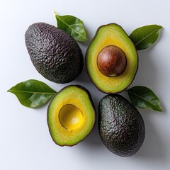 Cut open avocados reveal their creamy interior against a neutral backdrop