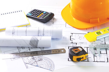 Architects concept, project house, Construction plans with yellow helmet and drawing tools on...