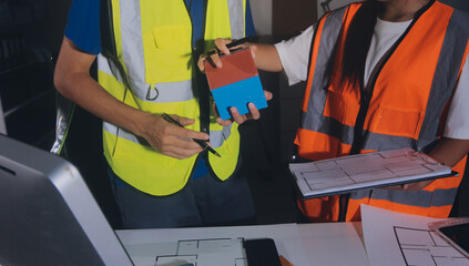 Closeup of team of industrial engineers meeting analyze machinery blueprints consult project on...