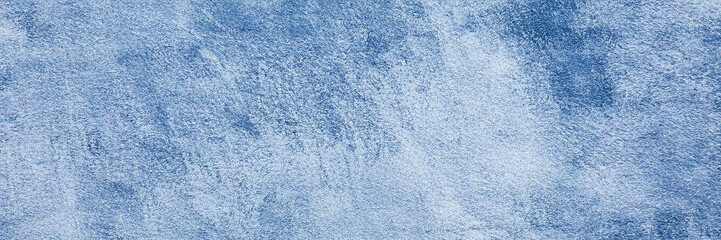 Blue grunge texture is seen on rough, matte surface; for digital wallpaper, video backdrop, or...