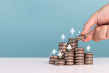 Invest,Investment,profit,saving money and planning businesses. Man holds coin in his hand with...