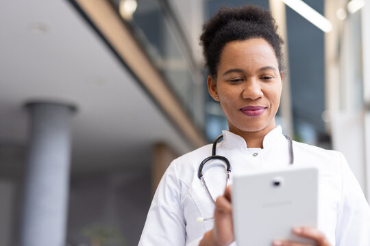 Confident medical professional using modern technology for patient care, enhancing healthcare efficiency and accessibility - Powered by Adobe