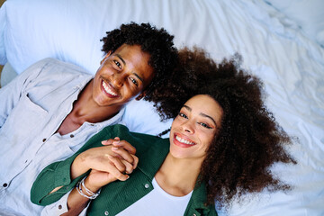 Portrait of a lovely young couple together, bonding hugging and relaxing at home