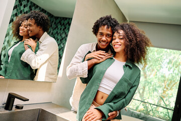 Portrait of a lovely young couple together, bonding hugging and relaxing at home