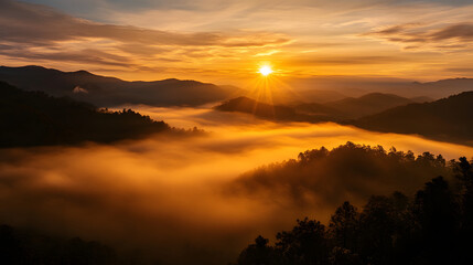 Fototapeta premium Dense morning fog rolling over the hills and valleys, with the sun starting to rise behind distant mountain ranges.