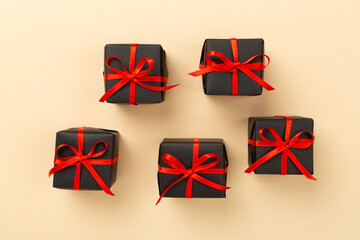 Black gift boxes on color background, top view. Black Friday concept
