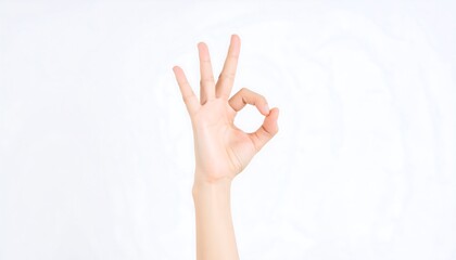 A fair-skinned hand makes the "OK" gesture against a white background