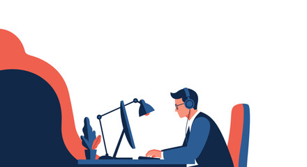 Focused professional working intently on a computer with headphones and a desk lamp providing focused illumination