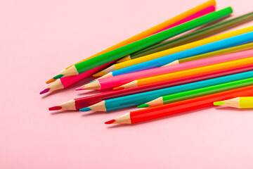 Colored pencils on a bright colored background. Equipment for coloring. Stationery for...