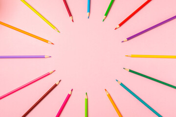 Colored pencils on a bright colored background. Equipment for coloring. Stationery for...
