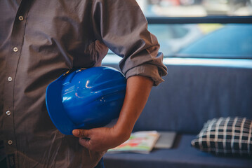 Construction engineer man hold blueprint wear blue shirt safety white hard hat at construction site...
