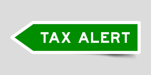 Green color arrow shape sticker label with word tax alert on gray background
