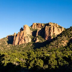 Sunlit rocky mountain landscape, clear sky