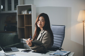Portrait of young Hispanic professional business woman standing in office. Happy female company...