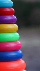 Colorful plastic rainbow toy pyramid for little kids. Educational toys, kids playground
