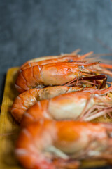 Selective focus boiled shrimp river or freshwater prawn in wood plate, ready to eat