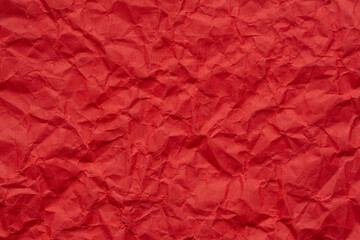 Fototapeta premium Close-up macro of wrinkled red paper texture,Wrinkled red paper texture,Rectangular crumpled sheet of red paper on a white isolated background.