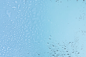 Blue glass with water drops. Wet glass.