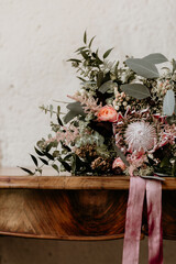 Rustic floral wedding bouquet on wooden table
