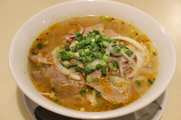 Vietnamese cuisine: pho bo hue (spicy rice noodles with beef)