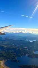Aerial view of mountains, valleys, and water from airplane
