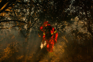 Firefighters in action putting out large flames during emergency fire